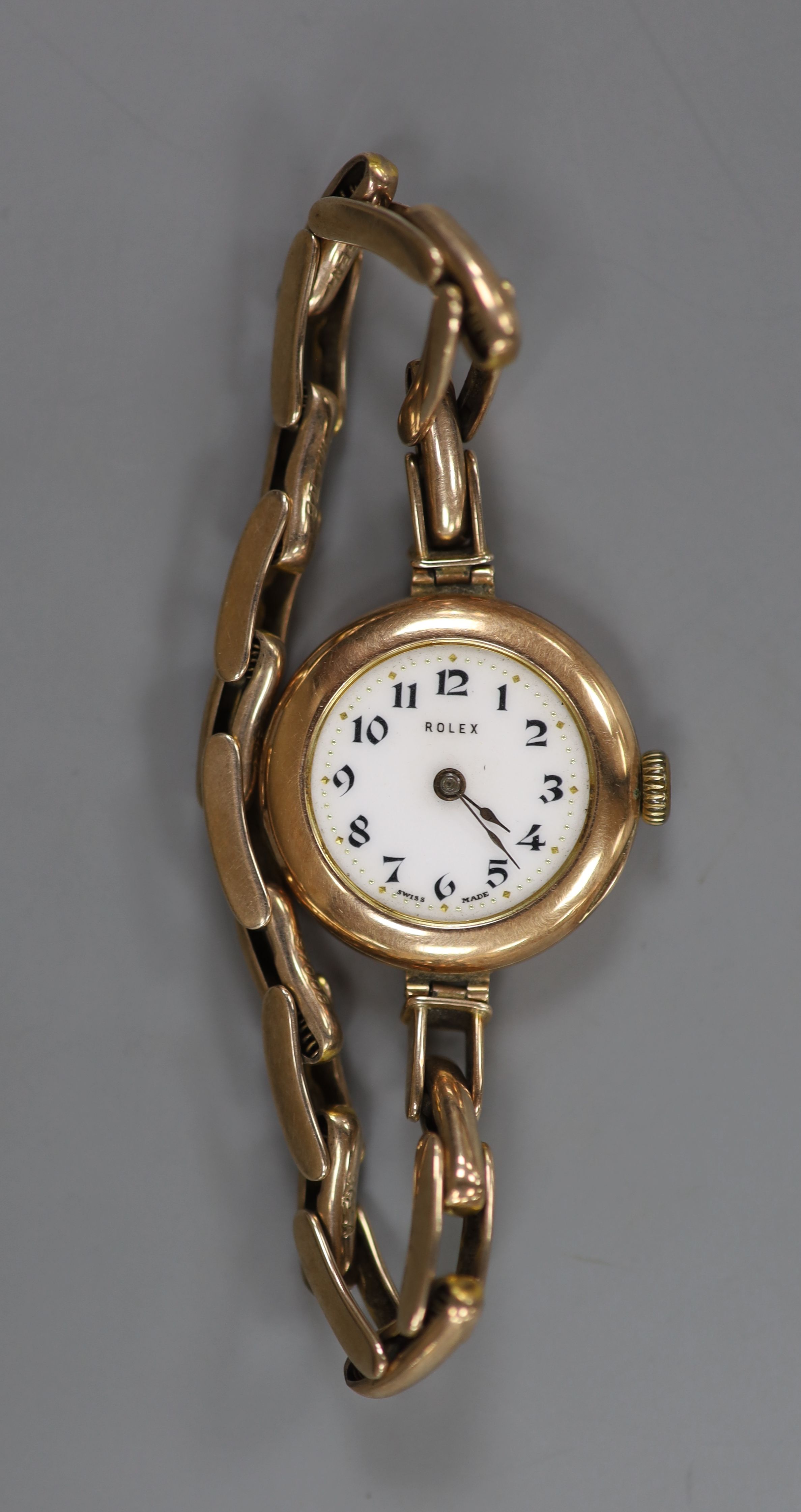 A lady's early 20th century 9ct gold Rolex manual wind wrist watch, on a 9ct flexible bracelet (no glass)